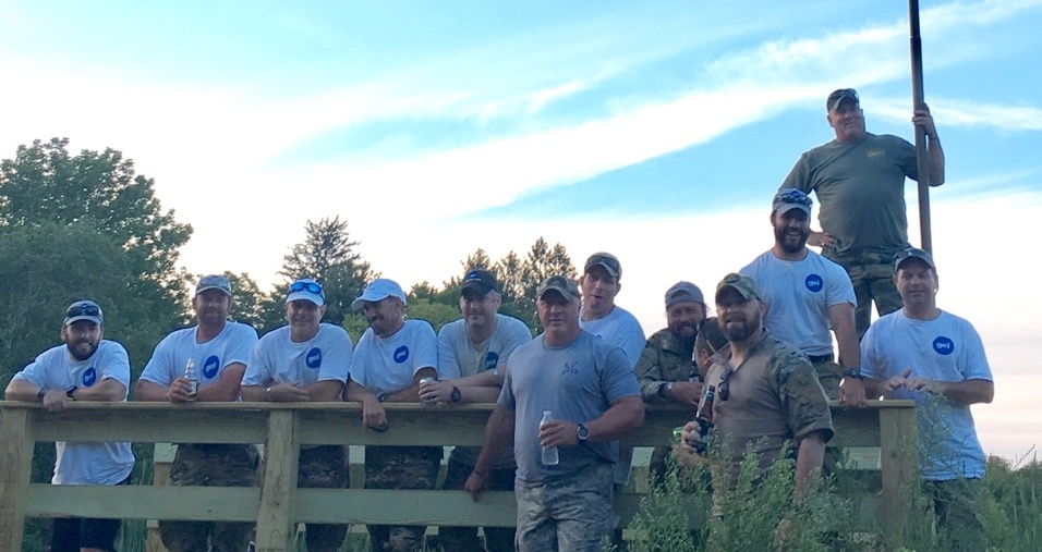 Team of rangers leaning against a fence