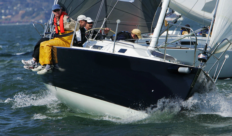 Crew sailing a boat in the waves